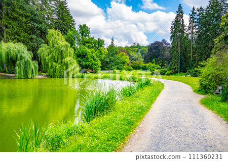 Beautiful lush green natural castle park on sunny summer day 111360231