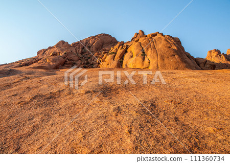 Pontok Mountains near Spitzkoppe. Red vivid granite rock formation in Namib Desert at sunset time, Namibia, Africa 111360734