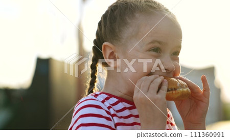 Funny cute little girl fooling eating big piece of fast food burger cheeseburger hamburger enjoy happy childhood. Cheerful female kid child biting junk meal with bun and meat bright sun light outdoor Funny cute little girl fooling eating big piece of fast food burger cheeseburger hamburger enjoy happy childhood. Cheerful female kid child biting junk meal with bun and meat bright sun light outdoor 111360991