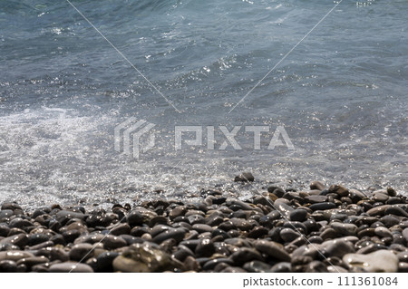 Rocky beach and pebble stones at sea 111361084