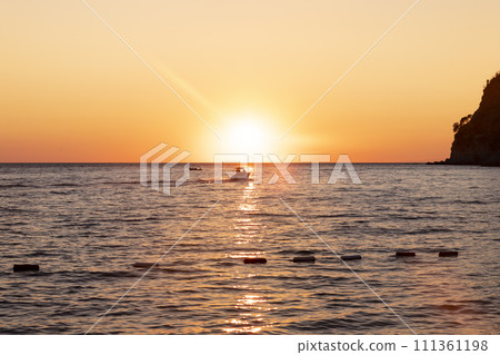 Boat sailing at sea at amazing sunset Boat sailing at sea at amazing sunset 111361198