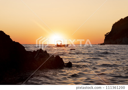 Boat sailing at sea at amazing sunset Boat sailing at sea at amazing sunset 111361200
