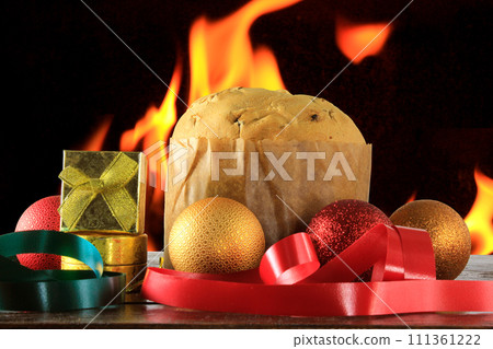 panettone, decorative christmas food, on wooden table, fire background panettone, decorative christmas food, on wooden table, fire background 111361222