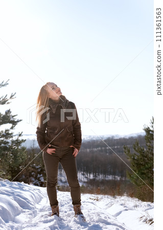 Beautiful girl in winter forest. Happy young woman walking in winter forest Beautiful girl in winter forest. Happy young woman walking in winter forest 111361563