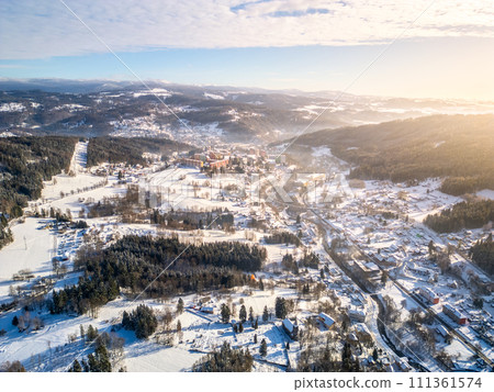 Tanvald in wintertime. Small town in Jizera Mountains, Czechia. Aerial photography from above. 111361574