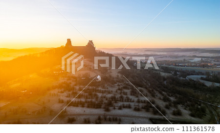 Trosky medieval castle ruins at cold morning sunrise time. Bohemian Paradise, Czech: Cesky raj, Czechia. Aerial view from above. 111361578