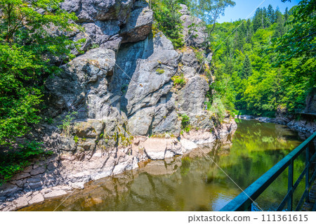 Wooden bridge pathway above Jizera River. Rieger Trail between Semily and Spalov. Czechia Wooden bridge pathway above Jizera River. Rieger Trail between Semily and Spalov. Czechia 111361615