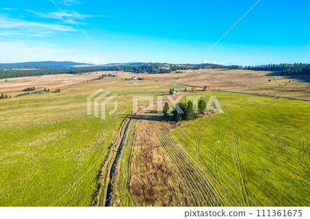 Blatna irrigation canal in the middle of autumn landscape at Ryzovna, Ore Mountains, Czech: Krusne hory, Czechia. Aerial view from drone. 111361675