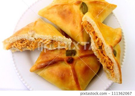 Chicken esfiha of arabic origin traditionally adapted for brazilian cuisine on plate on white background 111362067