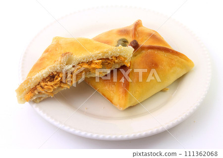 Chicken esfiha of arabic origin traditionally adapted for brazilian cuisine on plate on white background 111362068