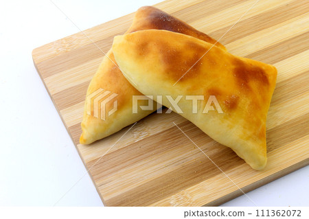 meat esfira (sfiha) of arabic origin traditionally adapted for brazilian cuisine on wooden spatula meat esfira (sfiha) of arabic origin traditionally adapted for brazilian cuisine on wooden spatula 111362072