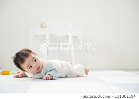 0 year old baby lying on stomach 0 year old baby lying on stomach 111362194