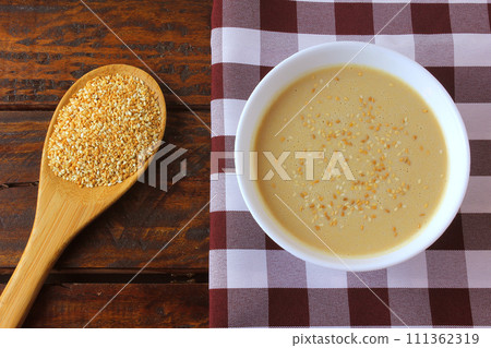 Tahini in ceramic bowl on rustic wooden table- cream or paste made from sesame seeds (sesame) widely used in Middle Eastern cuisine 111362319