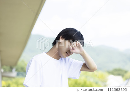 High school boy grieving 111362893