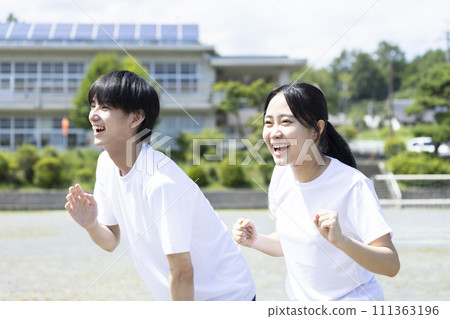 Students cheering in gym clothes Students cheering in gym clothes 111363196