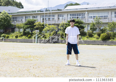 High school boy standing in the schoolyard 111363385