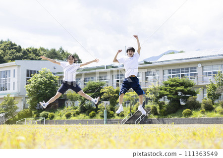 High school students jumping in the schoolyard High school students jumping in the schoolyard 111363549