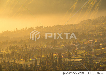 Spectacular sunrise over Cemoro Lawang village nearly Bromo Tengger Semeru National Park, Indonesia. Spectacular sunrise over Cemoro Lawang village nearly Bromo Tengger Semeru National Park, Indonesia. 111363632