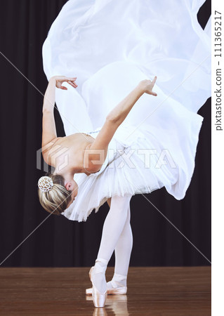 Woman after ballet performance, dancer practicing to be professional ballerina and dance in stage theatre or opera show. Energy, love and passion is a must for training in abstract or artistic career 111365217