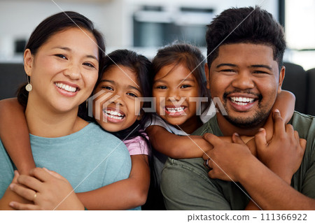 Family, smile and love of children for their mom and dad while sitting together in the lounge at home sharing a special bond. Portrait of happy Filipino man, woman and girl kids hugging their parents Family, smile and love of children for their mom and dad while sitting together in the lounge at home sharing a special bond. Portrait of happy Filipino man, woman and girl kids hugging their parents 111366922