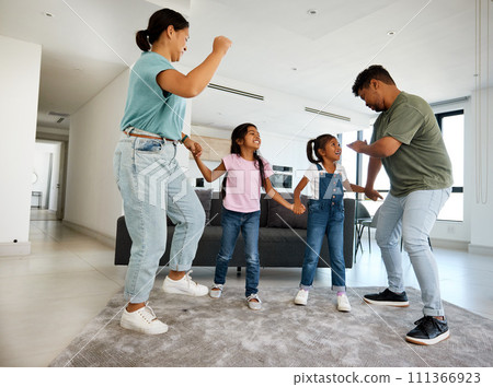 Family dancing, happy house and parents teaching children to dance, moving to music together and smile for love in home living room. Silly girl kids playing with fun mother and father in lounge Family dancing, happy house and parents teaching children to dance, moving to music together and smile for love in home living room. Silly girl kids playing with fun mother and father in lounge 111366923