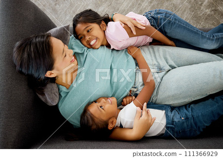 Happy family, children and mother bonding on a sofa with her daughter, relax and happy in a living room from above. Love, kids and mom laughing and loving, enjoying time together and being a parent 111366929