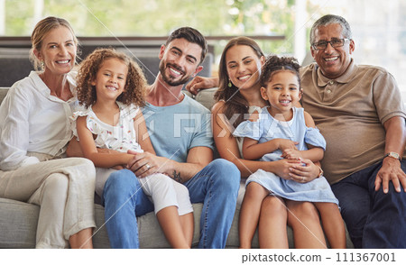 Interracial family, happy portrait and parents on the living room sofa with children, relax in lounge together and smile on the couch. Kids, mother and father with love for senior people in house Interracial family, happy portrait and parents on the living room sofa with children, relax in lounge together and smile on the couch. Kids, mother and father with love for senior people in house 111367001