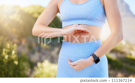 Hands, stomach and diet with a sports woman training, exercising or losing weight for good gut health and fitness. Exercise, workout and weightloss with a healthy female athlete framing her belly 111367214