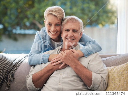 Couple, love and senior man and woman sitting on a sofa in the living room and enjoying retirement. Portrait of an elderly male and female pensioner in a home to relax and spend time together Couple, love and senior man and woman sitting on a sofa in the living room and enjoying retirement. Portrait of an elderly male and female pensioner in a home to relax and spend time together 111367474