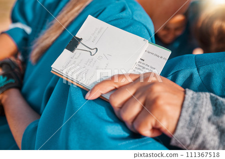 Notebook goals, sports coach hand and girl team in baseball or softball training with group of people hug together for strategy or motivation. Coaching teamwork notes list on women athlete progress Notebook goals, sports coach hand and girl team in baseball or softball training with group of people hug together for strategy or motivation. Coaching teamwork notes list on women athlete progress 111367518