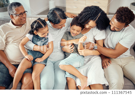 Big family, bonding fun and love of children, parents and grandparents while sitting together on the sofa at home. Happy, laughing and tickling while sharing a special moment with men, women and kids Big family, bonding fun and love of children, parents and grandparents while sitting together on the sofa at home. Happy, laughing and tickling while sharing a special moment with men, women and kids 111367545