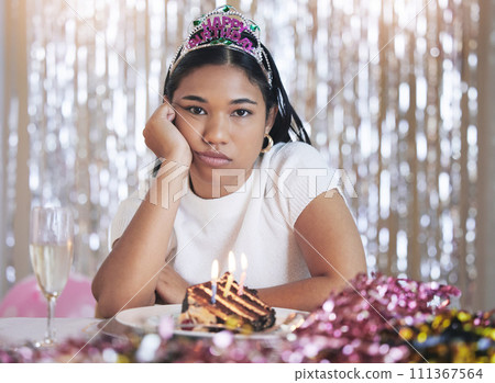 Bored, angry and birthday girl at a party at a celebration event with cake and candles upset. Portrait of a person from Mexico with sweet food feeling frustrated, sad and unhappy celebrating 111367564