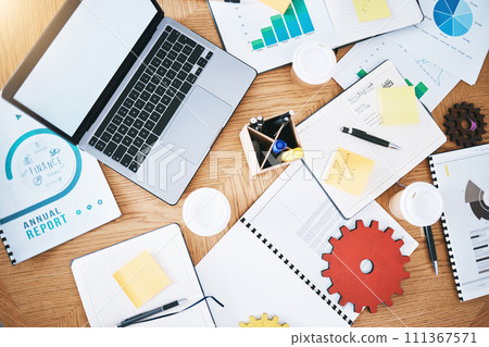 Documents, finance and report with a laptop, gear and paperwork on a table or desk in a corporate office from above. Notepad, stationery and graphs on a wooden surface in a workplace for planning Documents, finance and report with a laptop, gear and paperwork on a table or desk in a corporate office from above. Notepad, stationery and graphs on a wooden surface in a workplace for planning 111367571