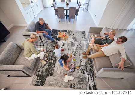 Big family in living room home with parents, baby or children play on carpet for growth, development and wellness. Overhead grandmother and grandfather talking to kids for language learning in lounge 111367714
