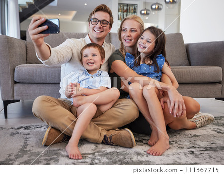 Selfie, phone and family with a man taking a picture with his children and their mother on the floor of their living room at home. Happy, love and kids with a brother and sister posing with parents Selfie, phone and family with a man taking a picture with his children and their mother on the floor of their living room at home. Happy, love and kids with a brother and sister posing with parents 111367715