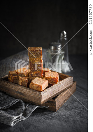 Brown sugar in wooden box on slate background 111367789