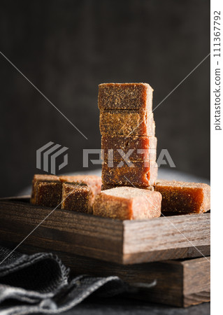 Brown sugar in wooden box on slate background 111367792