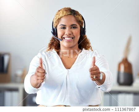 Thumbs up, crm and contact use with a call center agent working in customer service or telemarketing. Thank you, sales and support with a happy business woman working in her office with a headset Thumbs up, crm and contact use with a call center agent working in customer service or telemarketing. Thank you, sales and support with a happy business woman working in her office with a headset 111367807