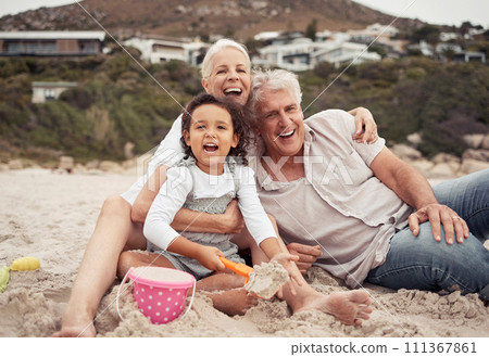 Family, time and beach with grandparents and grandchild laugh and play in sand, sitting and bonding in nature. Portrait of a happy girl enjoying seaside trip with senior man and woman, relax and fun 111367861