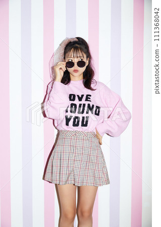 Retro portrait of young woman in pink outfit Retro portrait of young woman in pink outfit 111368042