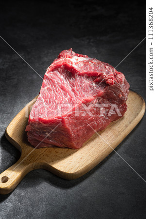 raw beef steak on a black background 111368204
