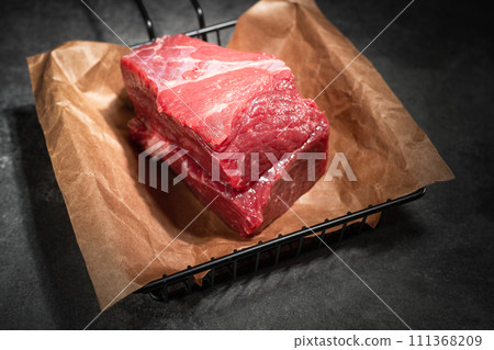 raw beef steak on a black background raw beef steak on a black background 111368209