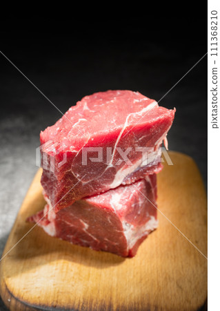 raw beef steak on a black background raw beef steak on a black background 111368210
