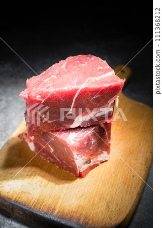raw beef steak on a black background 111368212