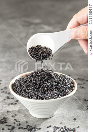 Put black rice in bowl 111368457