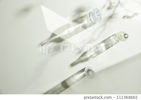 Natural texture of various glass cups on a table with sunlight streaming in. Natural texture of various glass cups on a table with sunlight streaming in. 111368602