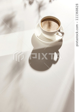 Natural texture of various glass cups on a table with sunlight streaming in. 111368628