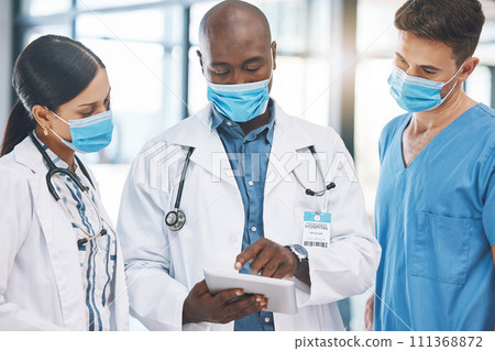 Doctor with tablet talk about data, diagnosis or strategy with team for covid management in hospital. Medic in meeting with staff, show information about virus or disease on mobile device at clinic 111368872