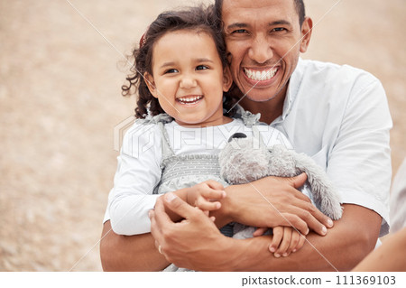 Happy family at beach, father gives kid a hug with smile on her face and laughing with dad. A summer getaway, traveling the world on vacation with family and holidays with friends is a great a break 111369103