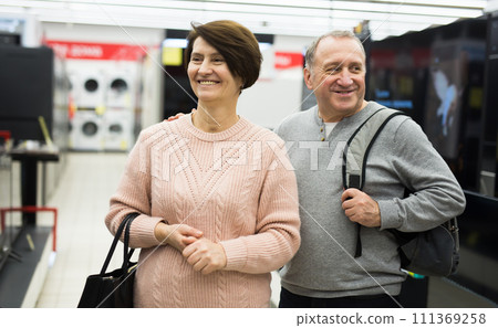 Senior couple shopping in tech store 111369258